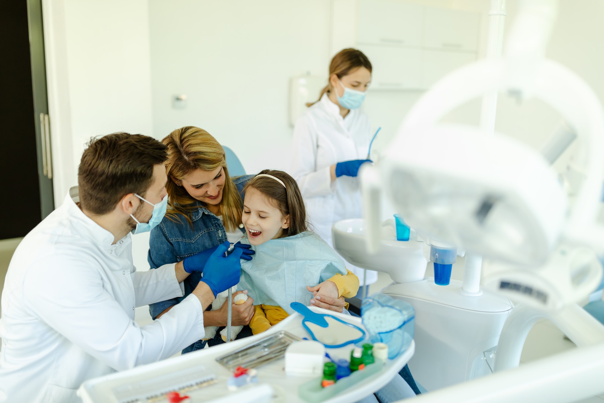 Little girl is not afraid to show teeth to dentist. Prophylactic examinations child at dentist